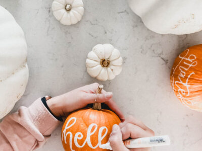 hand lettering with paint marker on pumpkins