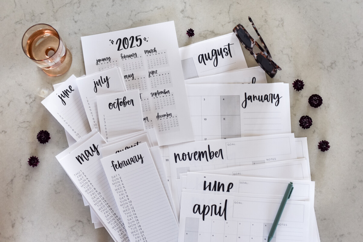 simple hand lettered collection of calendars including list calendars, perpetual calendars, monthly calendars, year at a glance calendar and large format calendars free printable for 2025, shown printed off on a marble countertop with green pen