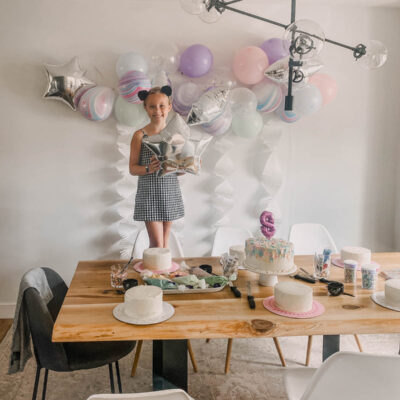 DIY Cake Decorating Party with pastel balloons and white fringe garlands