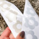 What is the best vinyl to use for my decals? a comparison- image of two sheets of flower decals, one in clay glossy permanent adhesive vinyl, one in light blue matte removable adhesive vinyl