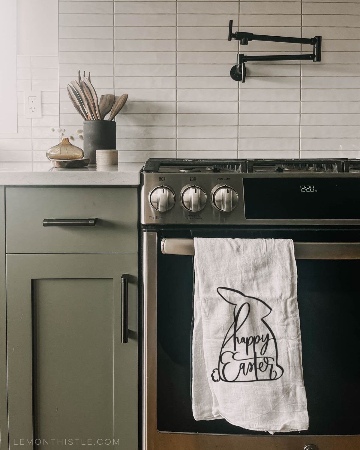 modern easter tea towel with black easter bunny silhouette and hand lettered 'happy easter'. towel hung over store handle