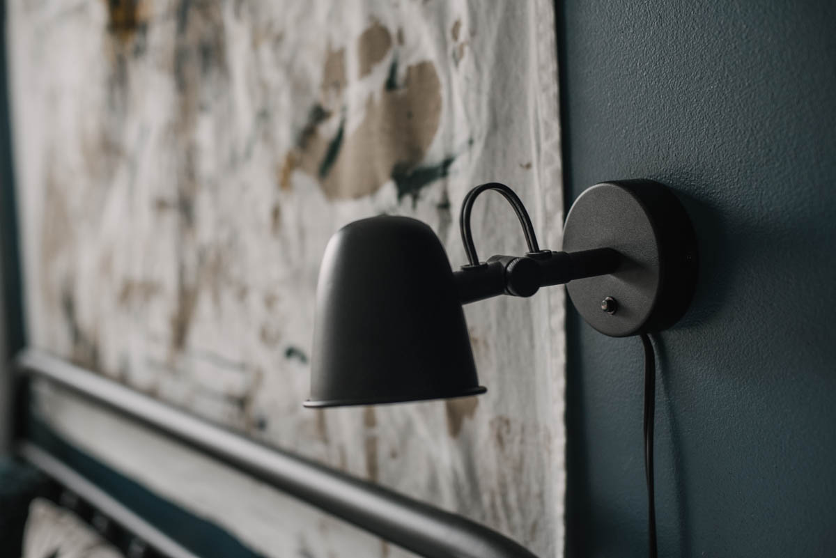 Wall sconce instead of bedside lamp to save space on the nightstand