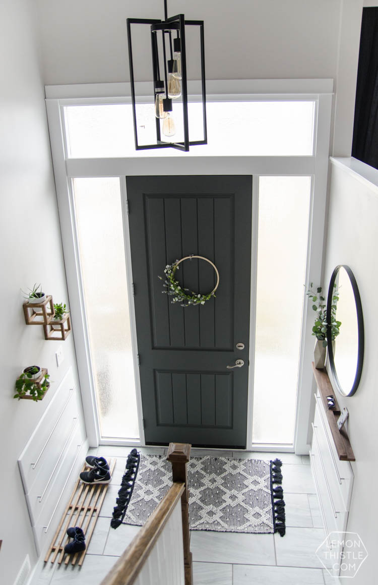 DIY Split Level Entry Makeover- I LOVE this entry. The oversize door, scandi influence and that shoe storage!