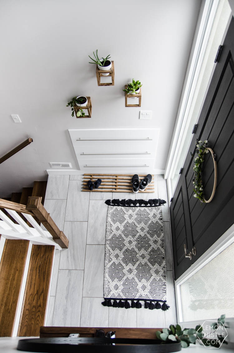 DIY Split Level Entry Makeover- I LOVE this entry. The oversize door, scandi influence and that shoe storage!