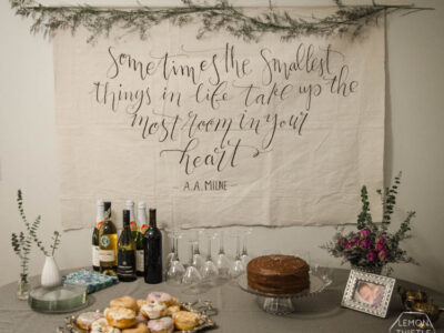 I LOVE this DIY giant canvas backdrop for a party... or a nursery. The hand lettering and floral garland is gorgeous! Plus, such great tips to paint thin lines on fabric.