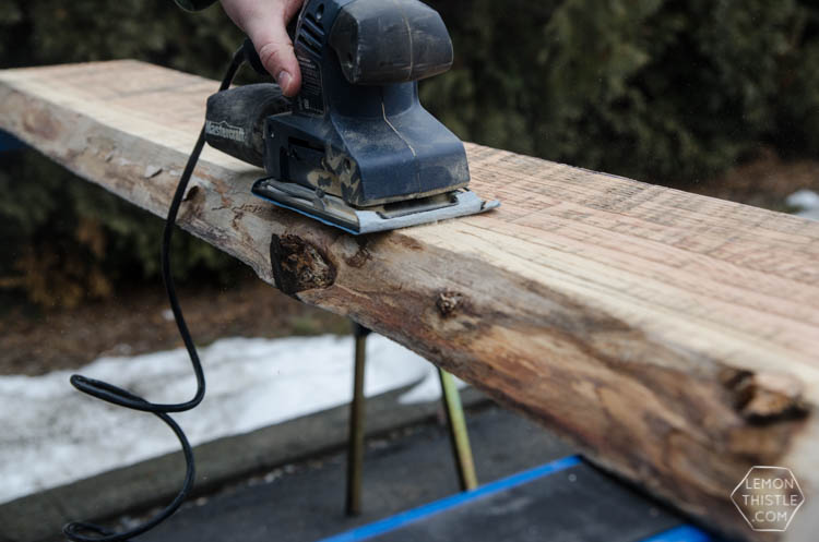 image shows sanding of rough cut live edge wood for a diy project image in a blog post about choosing wood for diy projects