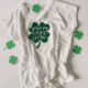 'you're my lucky charm' hand lettered on a shamrock ironed on to a tee shirt