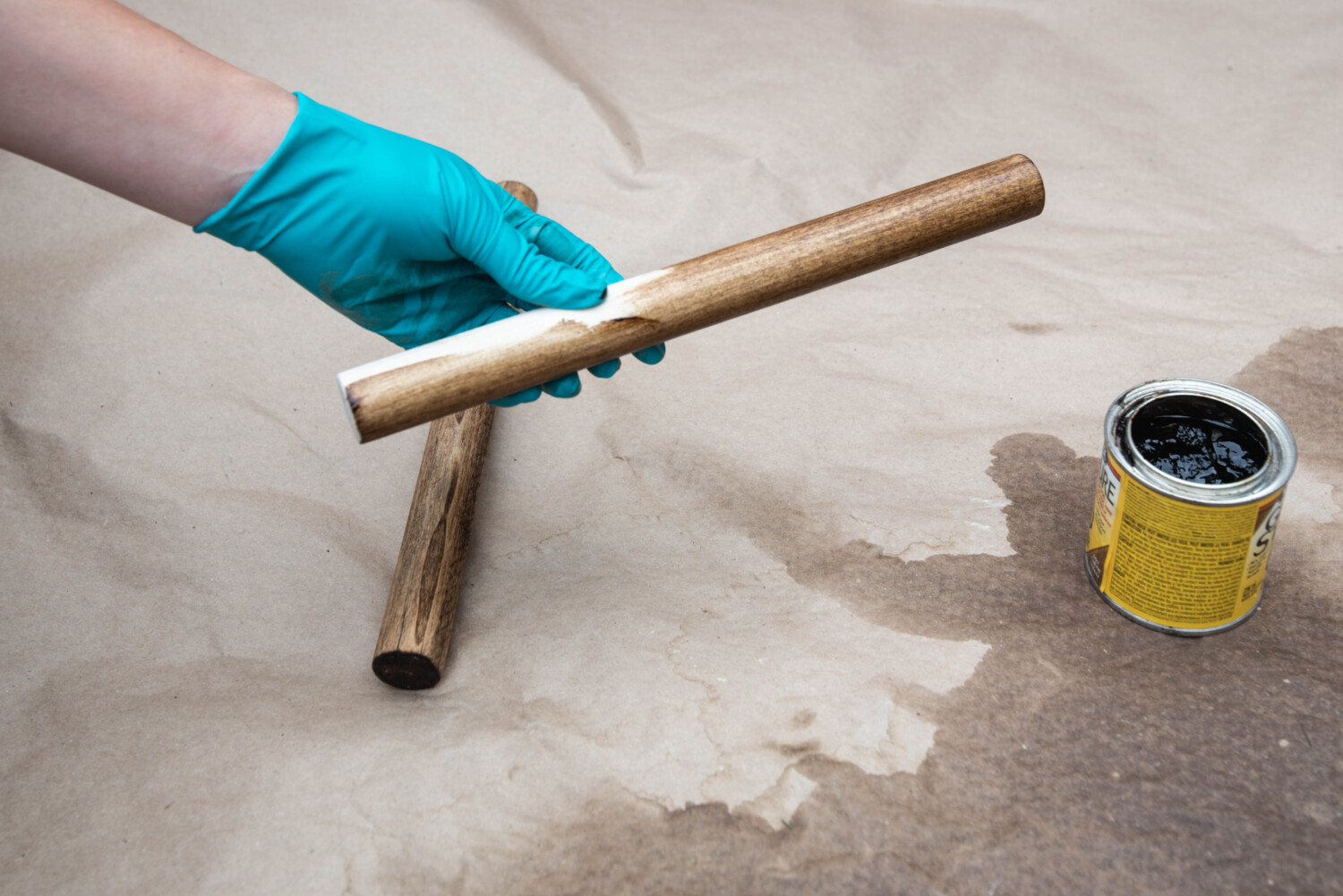 image shows dowels being stained for diy projects image in a blog post about choosing wood for diy projects