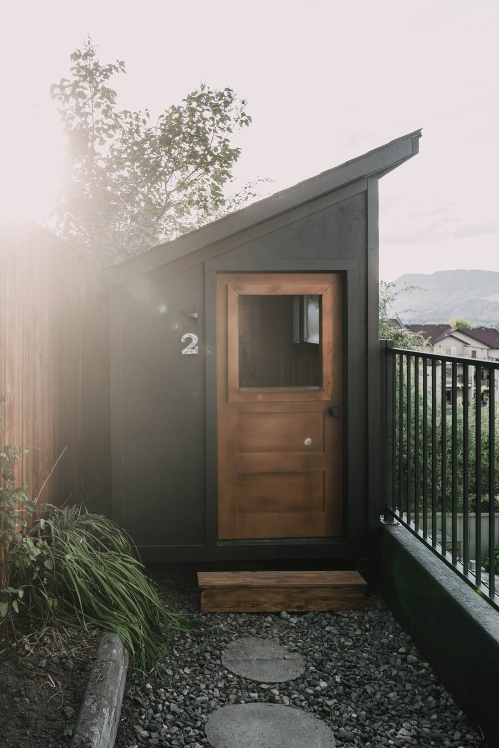 black playhouse with wooden door, modern playhouse design in blog post about the best black paint colour for your home 