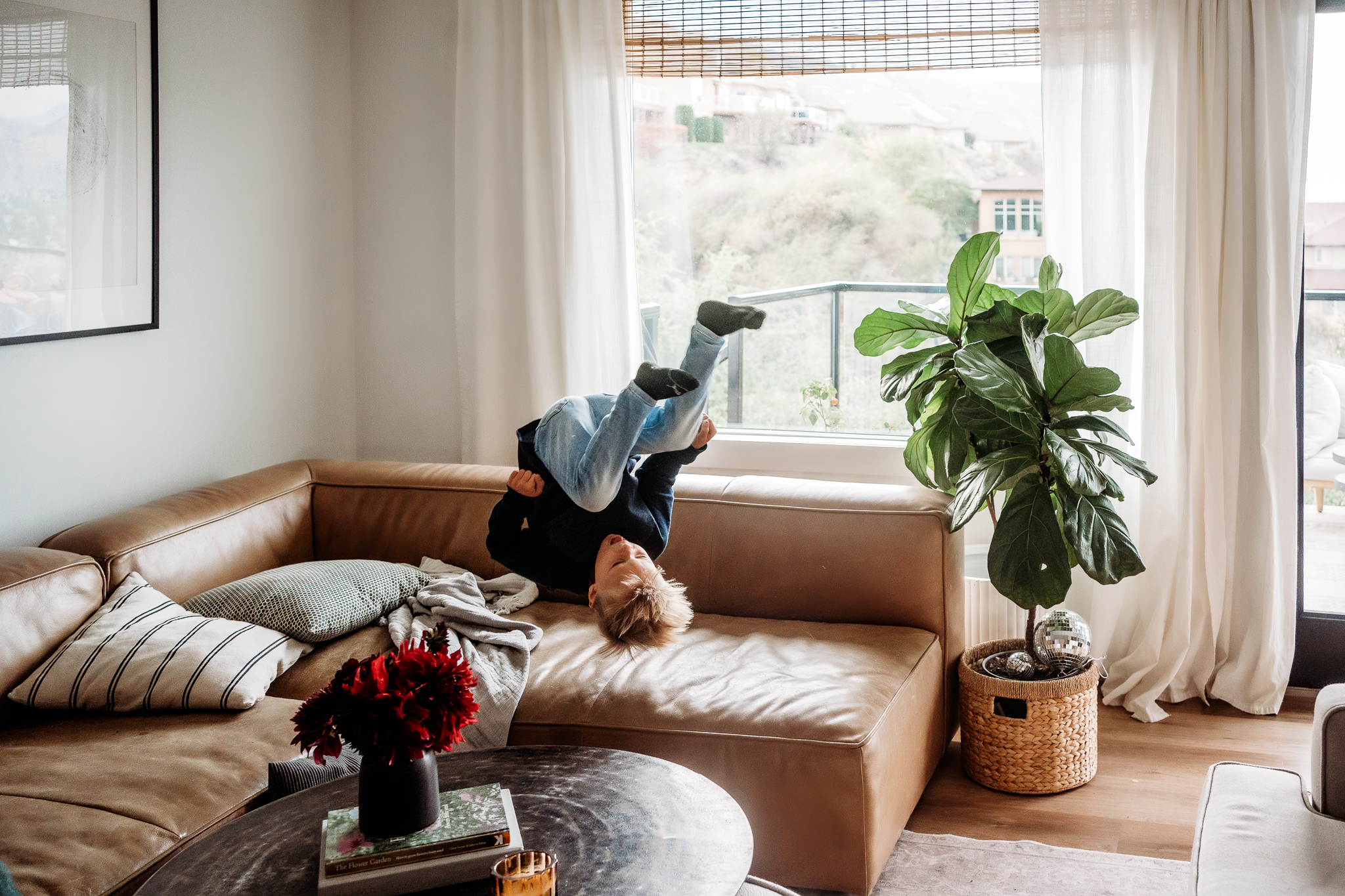 kid jumping on leather sofa
