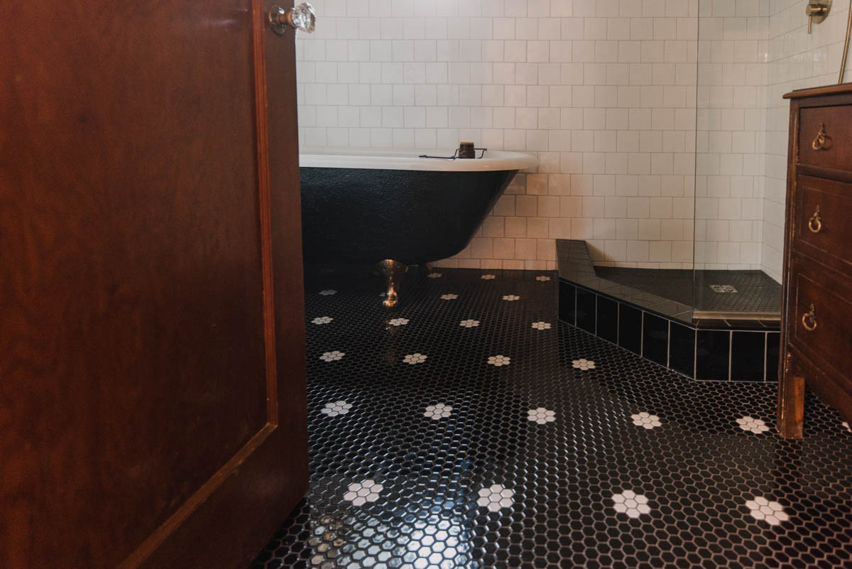 Black hexagon tile with white flowers