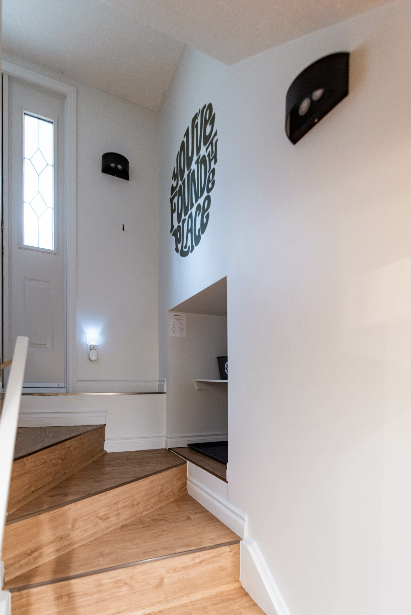 Entryway mural with retro vibes reads 'youve found the place'