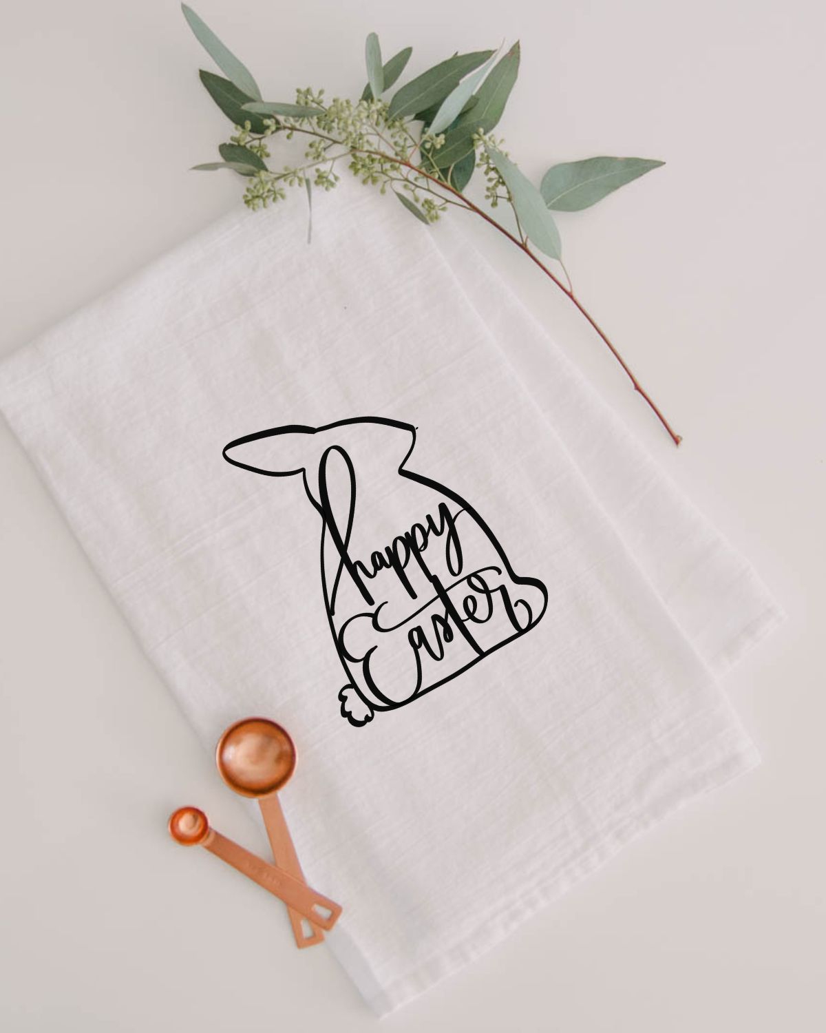 modern easter tea towel with black easter bunny silhouette and hand lettered 'happy easter'
