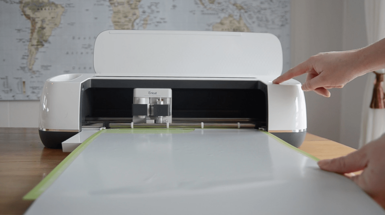 cricut maker being loaded with foil iron on